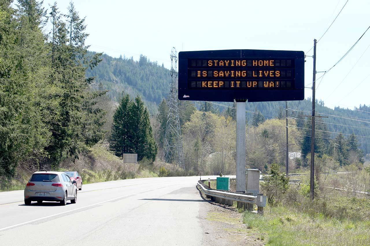 Electronic reader boards along highways across the state have read “stay home, limit travel, save lives” since Gov. Jay Inslee’s initial stay-home order last month. Now, signs are reading “staying home is saving lives, keep it up WA!” as testament to the success that social distancing and community mitigation measures have had in Washington on flattening the curve and limiting the spread of COVID-19. (Zach Jablonski/Peninsula Daily News)