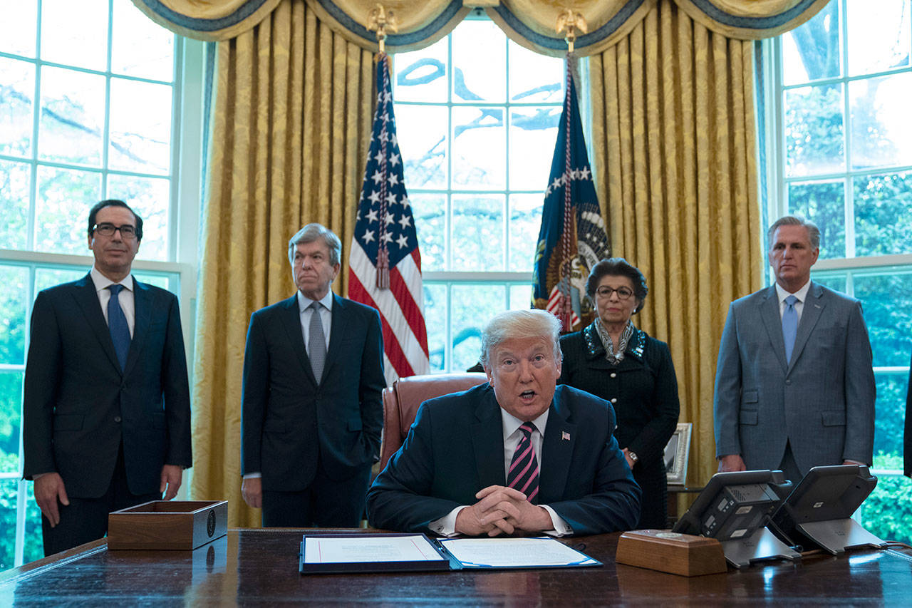 President Donald Trump speaks before signing a coronavirus aid package to direct funds to small businesses, hospitals, and testing, in the Oval Office of the White House on Friday, April 24, 2020, in Washington. From left, Treasury Secretary Steven Mnuchin, Sen. Roy Blunt, R-Mo., Trump, Small Business administrator Jovita Carranza, and House Minority Leader Kevin McCarthy of California. (Evan Vucci/Associated Press)