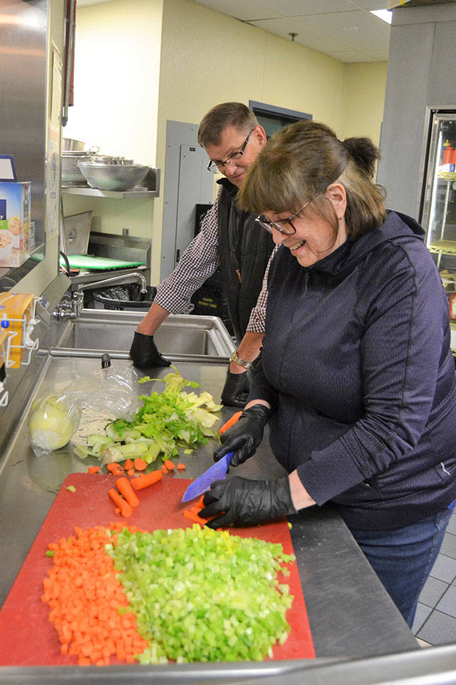 Barbara and Mike Lippert prep vegetables for soups to be delivered to apartment complexes from the Sequim unit of the Boys & Girls Clubs of the Olympic Peninsula. They were some of the first volunteers to step up to help prepare soups for local apartment complexes. (Matthew Nash/Olympic Peninsula News Group)