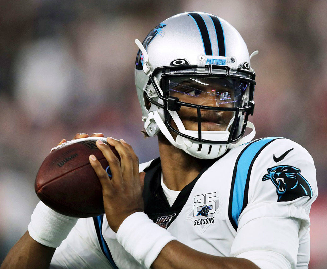 In this Aug. 22, 2019, file photo, Carolina Panthers quarterback Cam Newton warms up before an NFL preseason football game against the New England Patriots in Foxborough, Mass. While Newton remains optimistic about his chances of playing for the Panthers next season, the team is remaining mostly silent on the quarterback’s future. (Charles Krupa/Associated Press file)