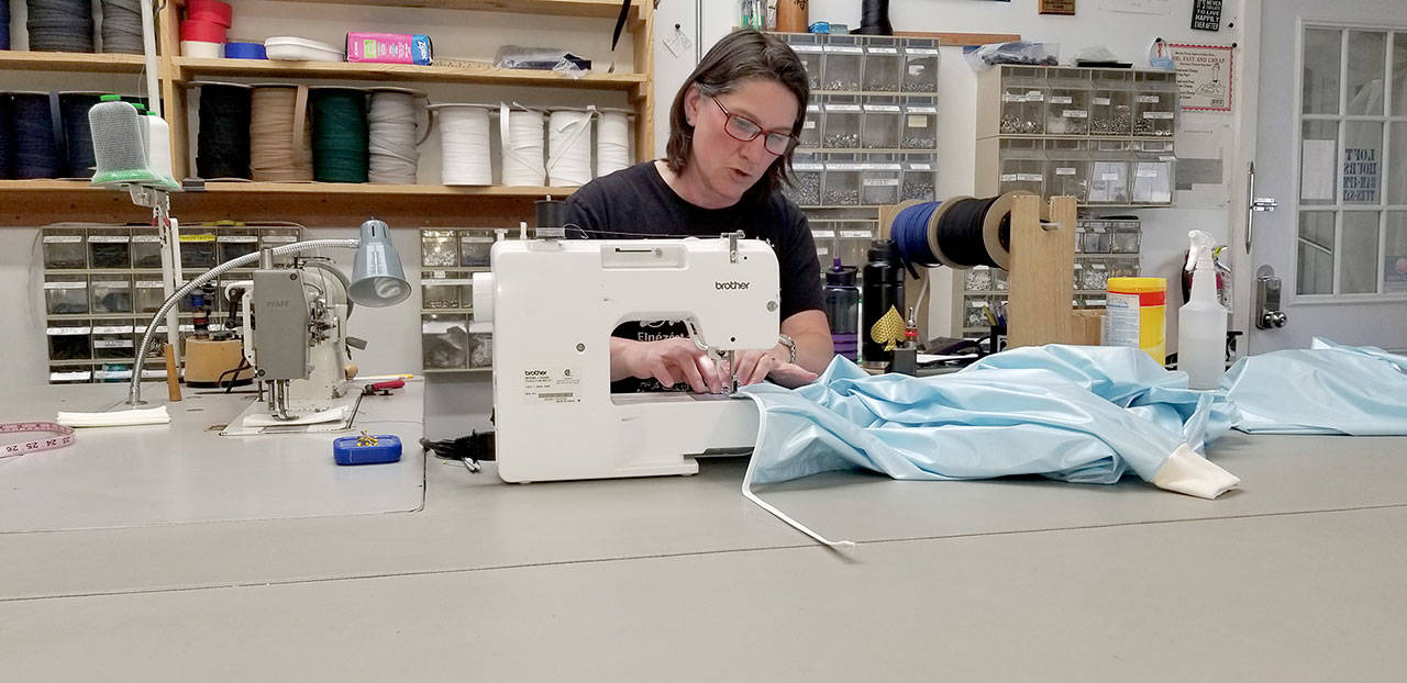 Daniele Johnson, canvas designer and seamstress for Sea Marine, works on sewing together a hospital gown that will go to Jefferson Healthcare. (Sea Marine)