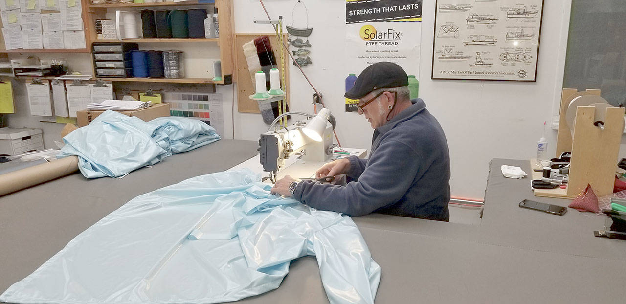 Jeff Johnson, canvas guru of Sea Marine, works on sewing together a hospital gown in the Sea Marine store. (Sea Marine)