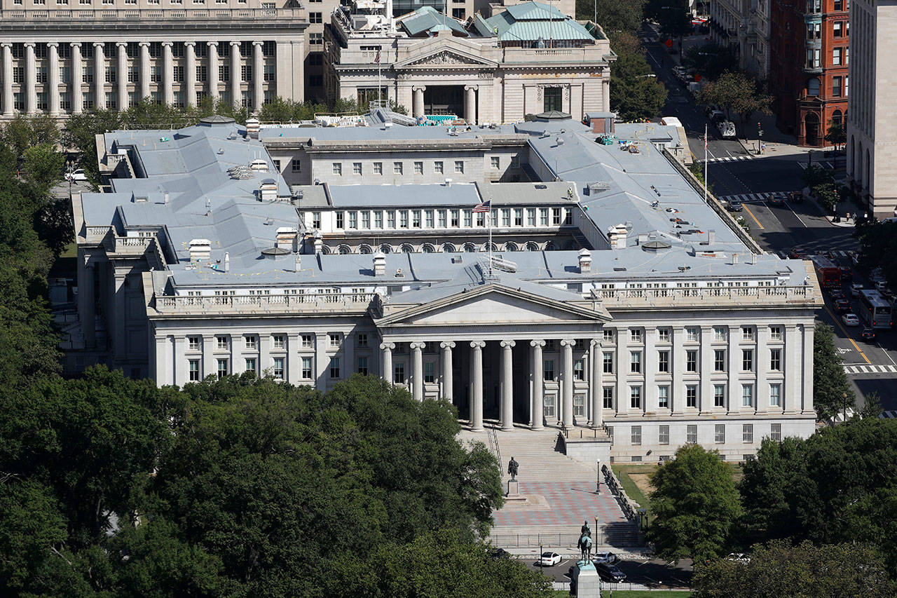 This Sept. 18, 2019, photo shows the U.S. Treasury Department building viewed from the Washington Monument in Washington. The Treasury Department says it will need to borrow a record $2.99 trillion during the current April-June quarter to cover the cost of various rescue efforts dealing with the coronavirus pandemic. Treasury said Monday, May 4, 2020 that the $2.99 trillion it plans to borrow this quarter will far surpass the $530 billion quarterly borrowing it did in the July-September 2008 quarter as it dealt with the 2008 financial crisis. The extraordinary sum of $2.99 trillion of borrowing in a single quarter dwarfs the $1.28 trillion the government borrowed in the bond market for all of 2019. (Patrick Semansky/Associated Press file)