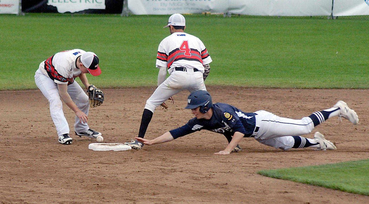 Wilder’s Milo Whitman, right, dives safely into second during a game against Australia White at the Firecracker Classic last July. Whitman, a Port Angeles High School senior, has signed to play baseball at Olympic College in Bremerton. (Keith Thorpe/Peninsula Daily News)