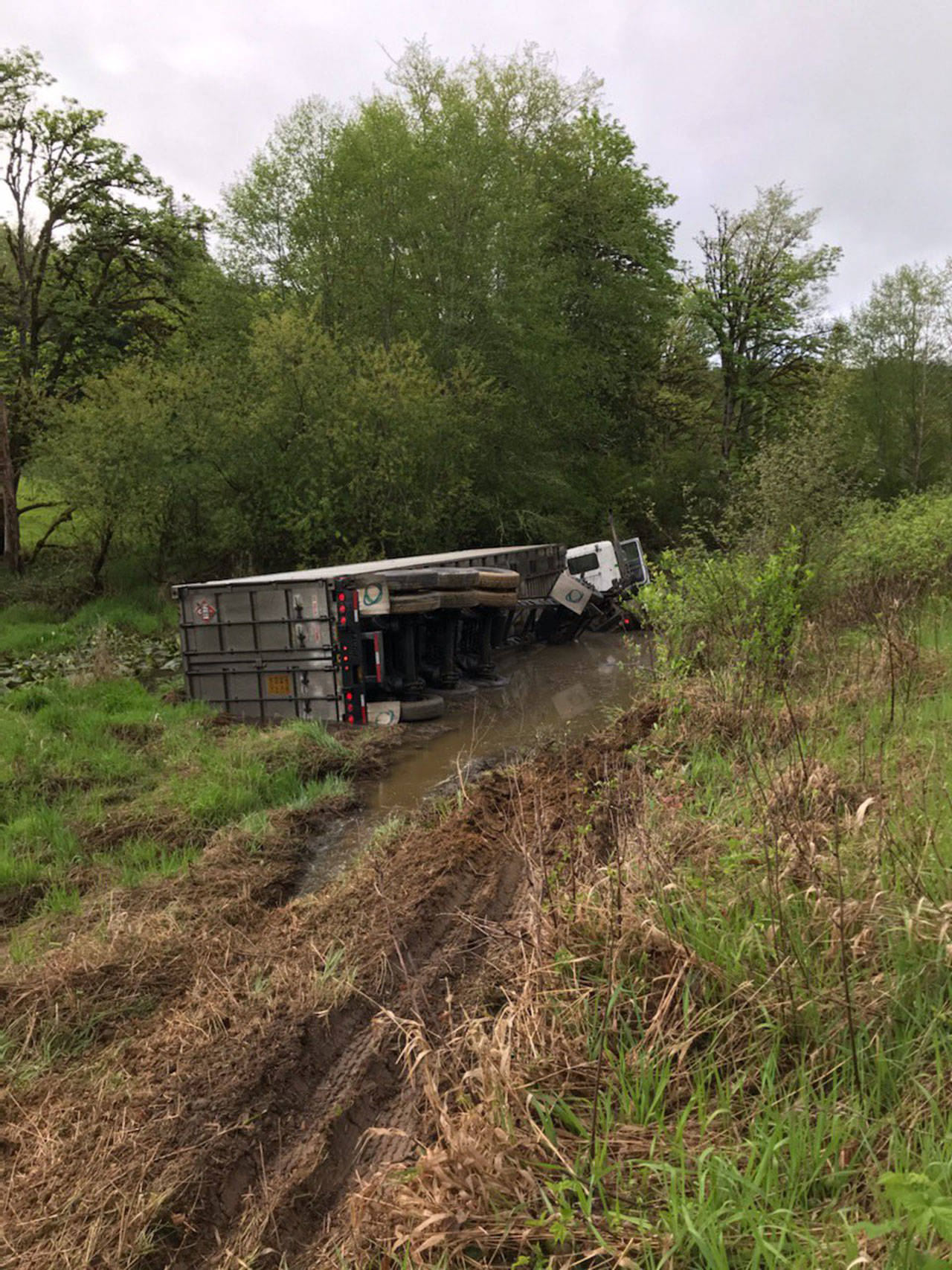A semi carrying propane tanks flipped over at Leland Cutoff Road in Quilcene at approximately 8 a.m. Wednesday, May 6, 2020. U.S. Highway 101 is fully blocked from the state Highway 104 interchange to Center Road and will be until the semi can be turned upright and towed. (Washington State Trooper Chelsea Hodgson)