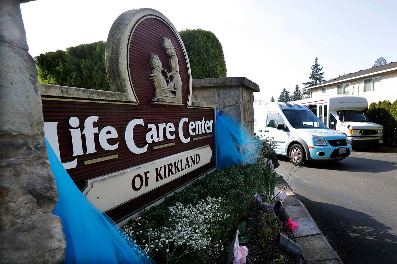 In this March 18, 2020, file photo, a vehicle leaves the Life Care Center in Kirkland, Wash. The long-term care facility was the site of the nation’s first deadly COVID-19 cluster and state authorities said Wednesday that 61 percent of coronavirus deaths in Washington have been at long-term care facilities. (AP Photo/Elaine Thompson/ Associated Press file)