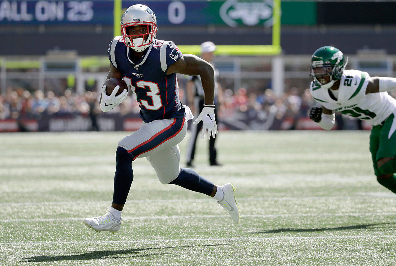 In this Sept. 22, 2019, file photo, New England Patriots wide receiver Phillip Dorsett, left, runs from New York Jets cornerback Nate Hairston (21) on the way for a touchdown after a reception during an NFL football game in Foxborough, Mass. Dorsett has never set foot in Seattle or anywhere in the Pacific Northwest. Not as a player in either of his previous NFL stops. Not in college. Not just for a random trip. He hasn’t even seen in person the the place he’ll practice after signing with the Seattle Seahawks whenever the facility becomes available to use. (Elise Amendola/Associated Press file)