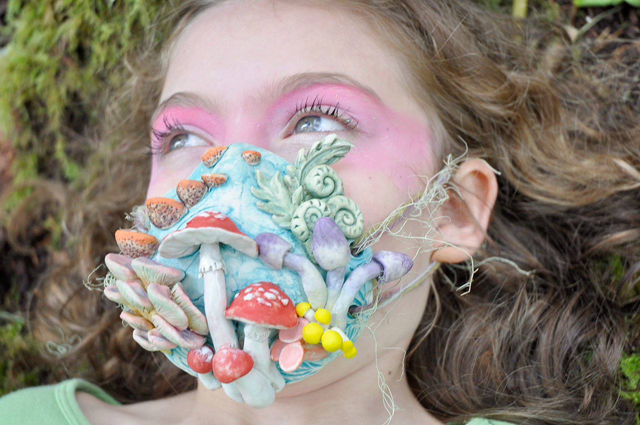 Sallie Nau’s “Alice in Wonderland” mask, modeled by her daughter, Kaya, 10, won first prize in the Port Townsend Wearable Art Show contest. (Photo by Sallie Nau)