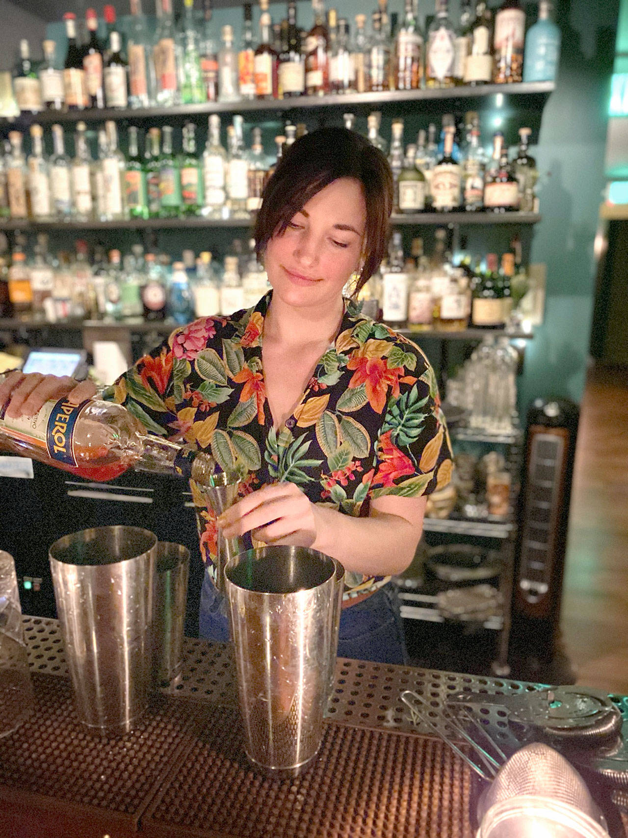 Sophia Elan, a co-manager and bartender of The In Between in Port Townsend, pours a drink while she works a shift prior to COVID-19 restrictions. Elan will represent The In Between bar crew by participating in an Instagram livestream event by PUNCH, which will donate $1,000 that will be split between the crew members. (Toby Warren)