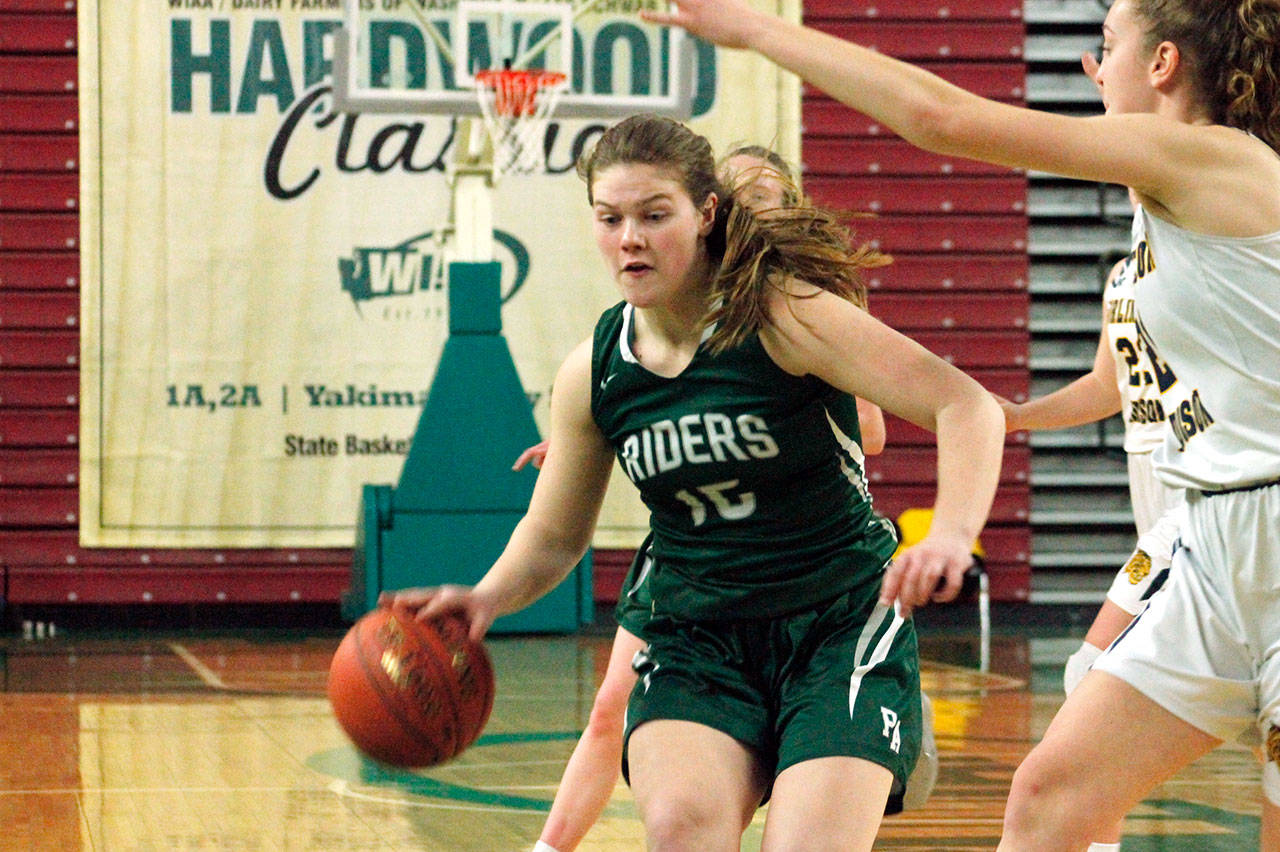 Port Angeles’ Myra Walker, left, dribbles while guarded by a Burlington-Edison defender during the Class 2A State Girls Basketball Tournament at the Yakima SunDome in March 2020. (Mark Krulish/Kitsap News Group file)