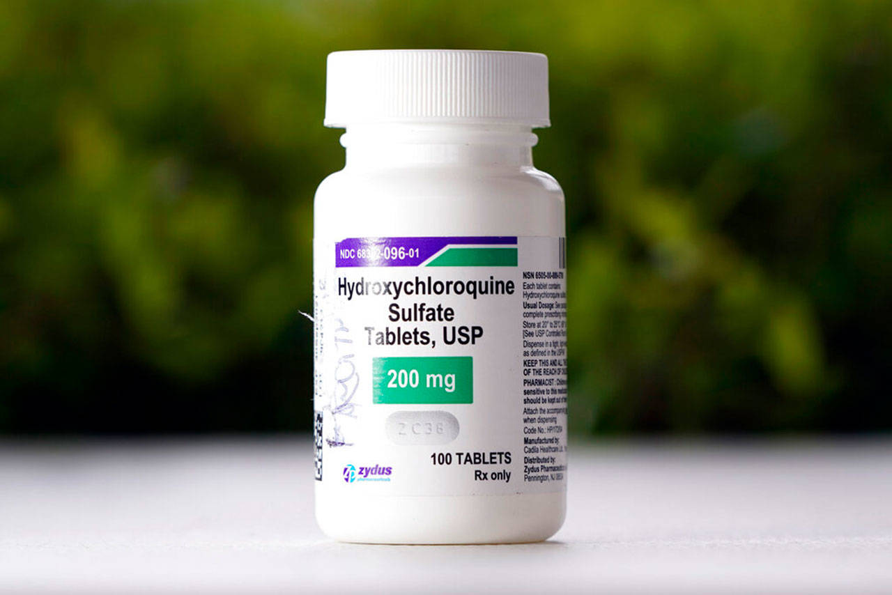 This Tuesday, April 7, 2020 file photo shows a bottle of hydroxychloroquine tablets in Texas City, Texas. The World Health Organization said Monday, May 25, 2020, that it will temporarily drop hydroxychloroquine from its global study into experimental COVID-19 treatments because its experts need to review all available evidence. (David J. Phillip/Associated Press file)