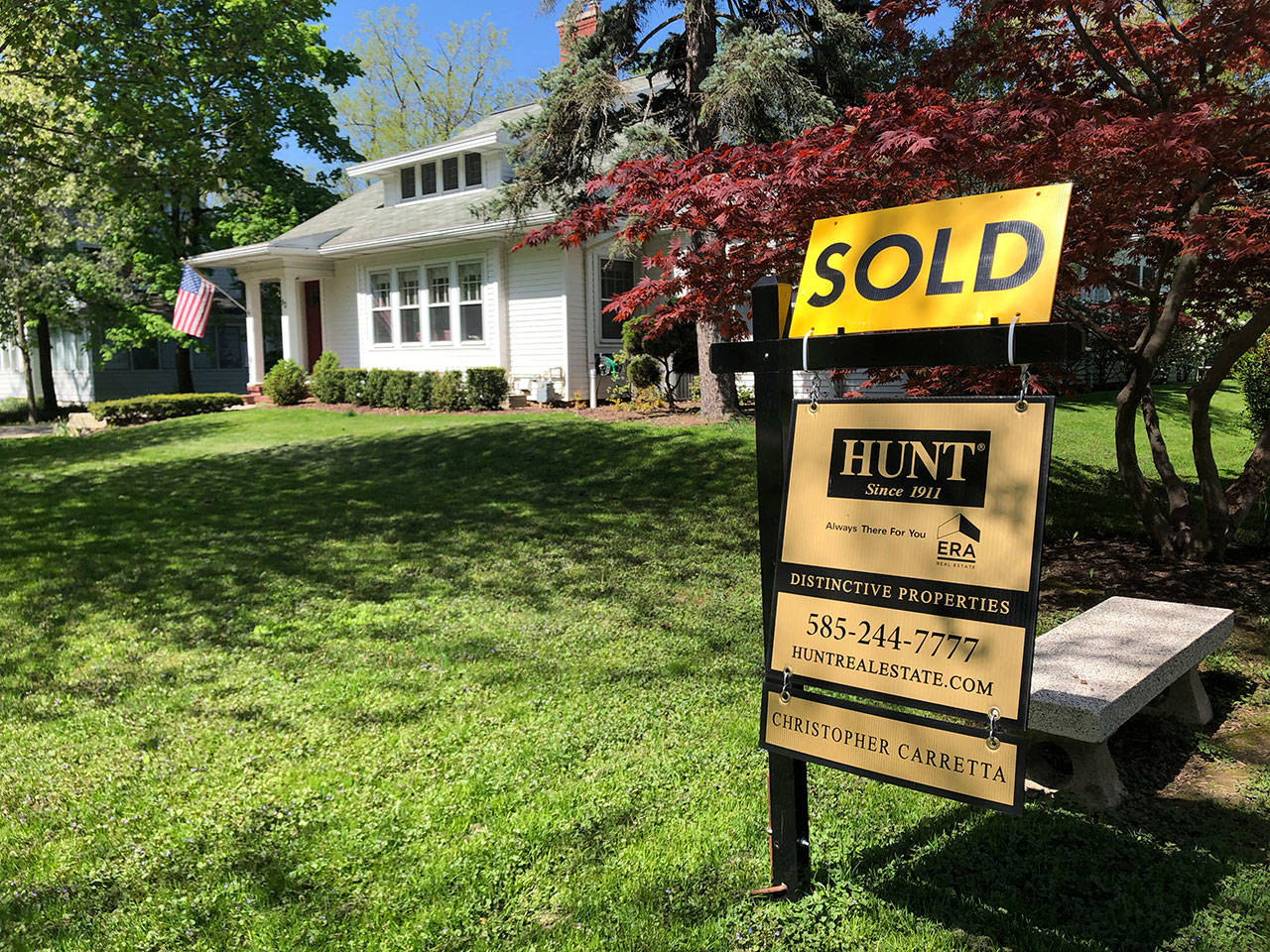 This May 22, 2020, photo shows a sold sign in front of a house in Brighton, N.Y. On Thursday, May 28, long-term U.S. mortgage rates fell this week as the key 30-year home loan marked an all-time low for the third time in the last few months since the coronavirus outbreak took hold. Mortgage buyer Freddie Mac reports that the average rate on the 30-year loan tumbled to 3.15 percent from 3.24 percent last week. (Ted Shaffrey/Associated Press)