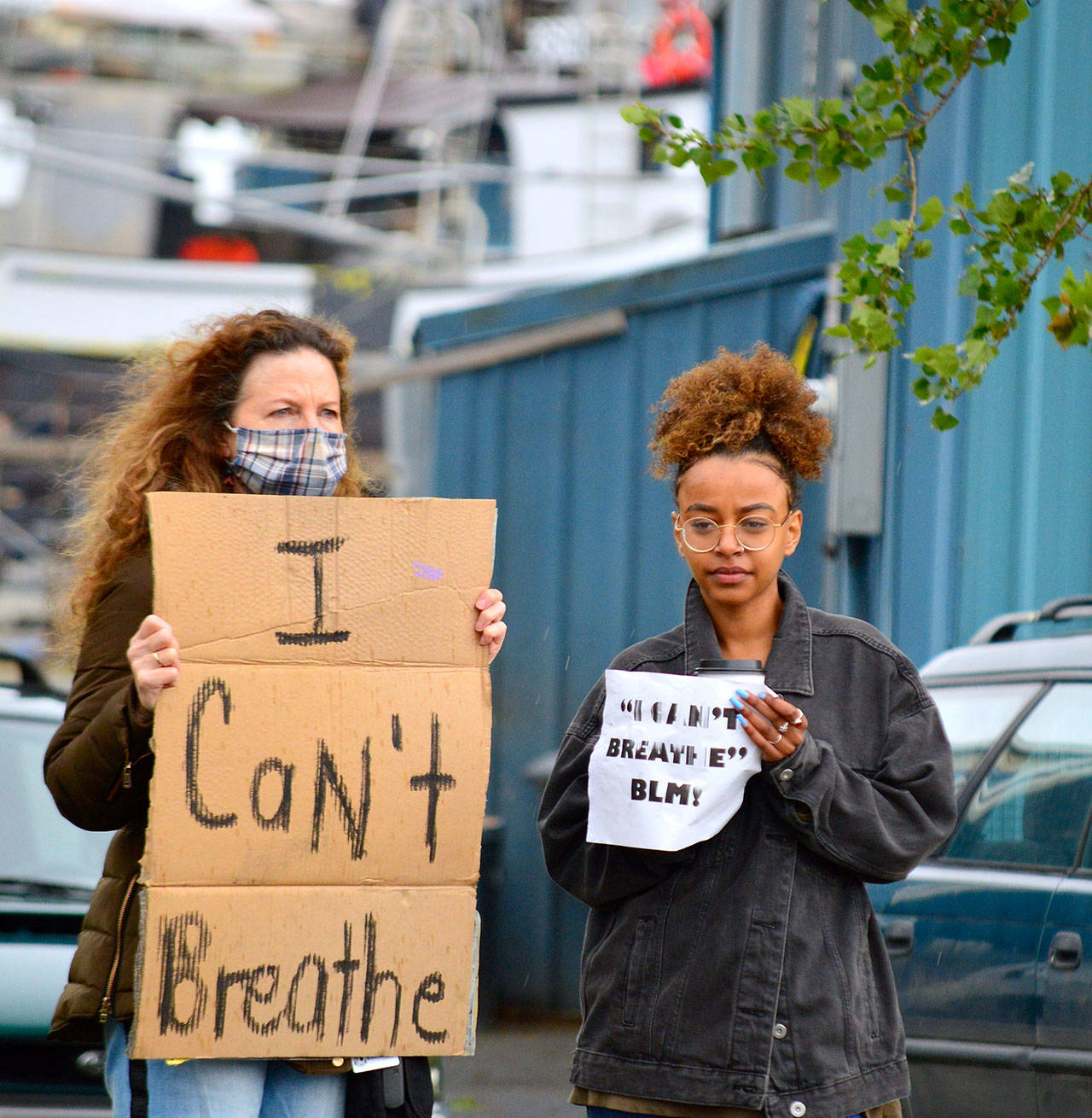 Juli Valentine, left, and her daughter Beth Valentine silently hold signs in Port Townsend on Saturday, May 30, 2020. (Diane Urbani de la Paz/for Peninsula Daily News)