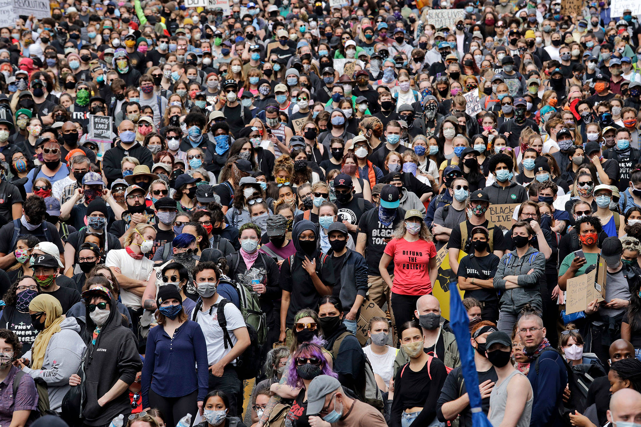 Peaceful protesters fill a street adjacent to Seattle City Hall on Wednesday, June 3, 2020, in Seattle, following protests over the death of George Floyd, a black man who was in police custody in Minneapolis. (Elaine Thompson/Associated Press)