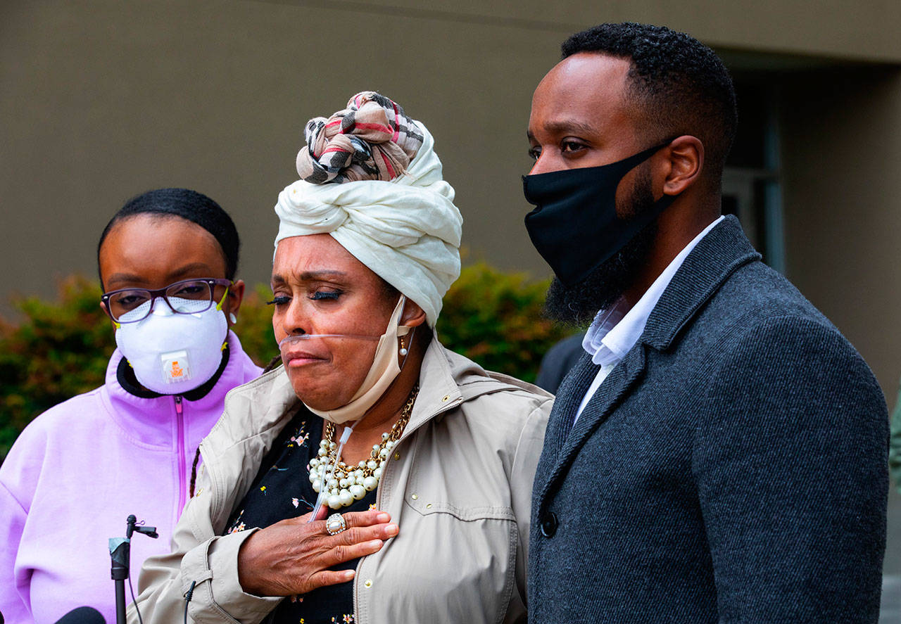Marcia Carter-Patterson, center, mother of Manny Ellis, speaks at a press conference in front of the Pierce County Superior Court in Tacoma on Thursday, June 4, 2020, regarding the killing of her son by Tacoma police. At left is Manny’s sister Monet Carter-Mixon and at right is his brother Matthew Ellis. Tacoma police’s restraint of Manuel Ellis caused his death the medical examiner has reported. The community has been protesting the death that happened March 3, 2020, for the past week. (Ellen M. Banner/The Seattle Times via AP)