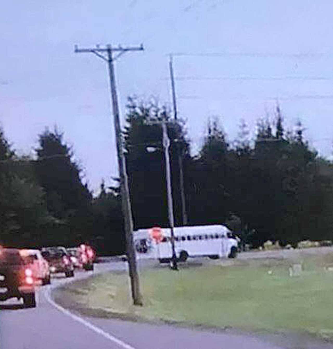 The Clallam County Sheriff’s Office is investigating video in an attempt to identify vehicles and people who may have harassed a family in Forks last week. The multiracial family was traveling in a white school bus as seen in this surveillance video image. (Clallam County Sheriff’s Office)