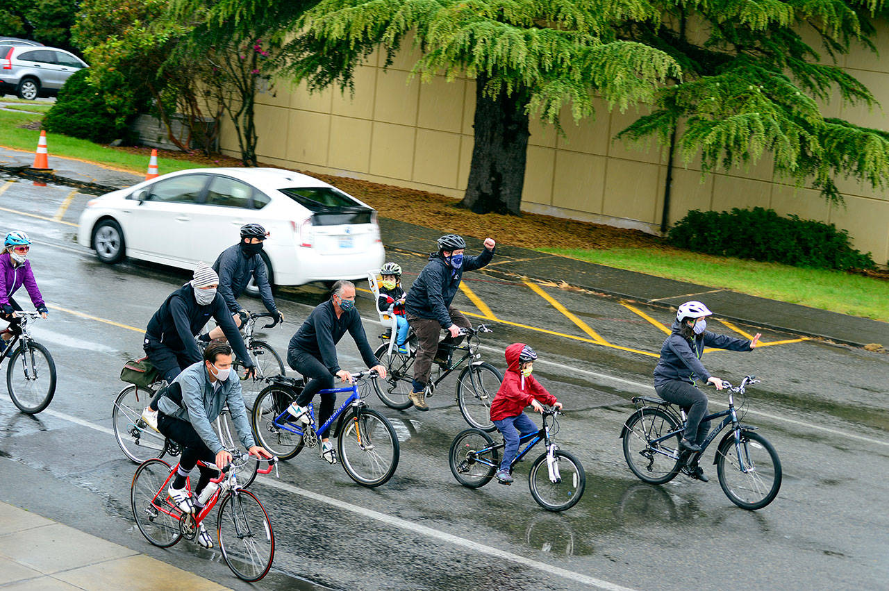 About 70 cyclists, including many parents and children, pedaled through Uptown Port Townsend’s wet streets in the People of Color & Allies Awareness Group Ride on Saturday morning. (Diane Urbani de la Paz/for Peninsula Daily News)                                About 70 cyclists, including many parents and children, pedaled through Uptown Port Townsend’s wet streets in the People of Color & Allies Awareness Group Ride on Saturday morning.