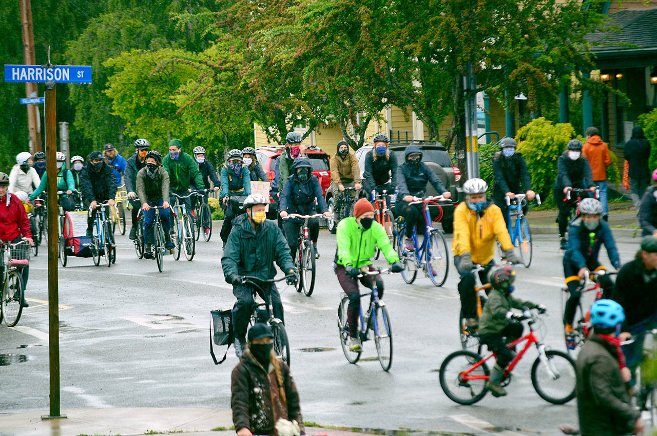 About 70 cyclists, including many parents and children, pedaled through Uptown Port Townsend’s wet streets in the People of Color & Allies Awareness Group Ride on Saturday morning. (Diane Urbani de la Paz/for Peninsula Daily News)
