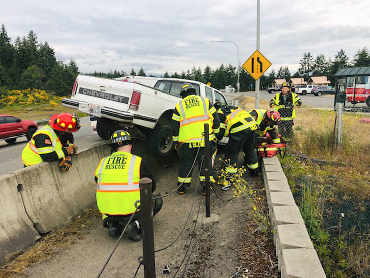 Crews from Clallam County Fire District 2 respond to a single-vehicle accident at the scenic overlook located just west of Deer Park Road on U.S. Highway 101 east of Port Angeles on Monday night. A 25-year-old Port Angeles man failed to negotiate the curve and collided with a concrete barrier located on the north side of the roadway. The driver was booked in the Clallam County Jail on DUI charges. (Clallam County Fire District 2)