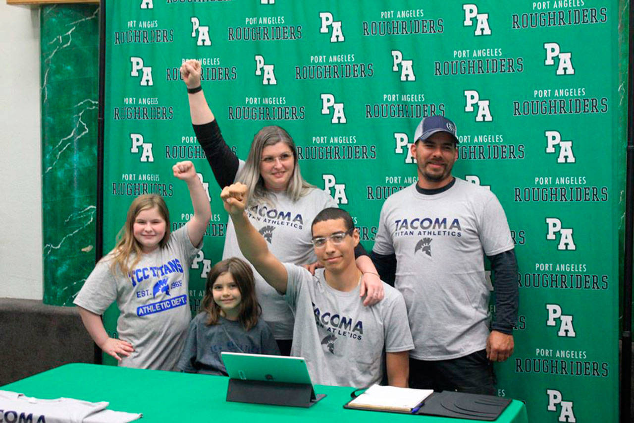 Port Angeles senior Damen Ringgold, center, signed a letter of intent to play basketball at Tacoma Community College. Ringgold was joined by, from left, sisters Abigail and Josephine Durham, mom Torie Garrett and stepdad Joseph Durham.