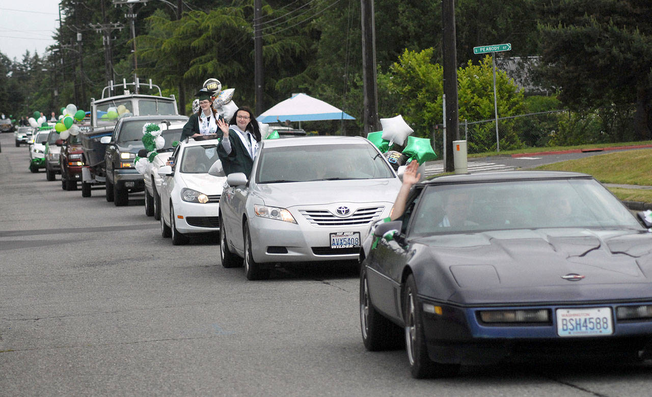 A line of vehicles containing graduating Port Angeles High School seniors makes its way up Park Avenue near the school during a graduation procession on Friday. (Keith Thorpe/Peninsula Daily News)