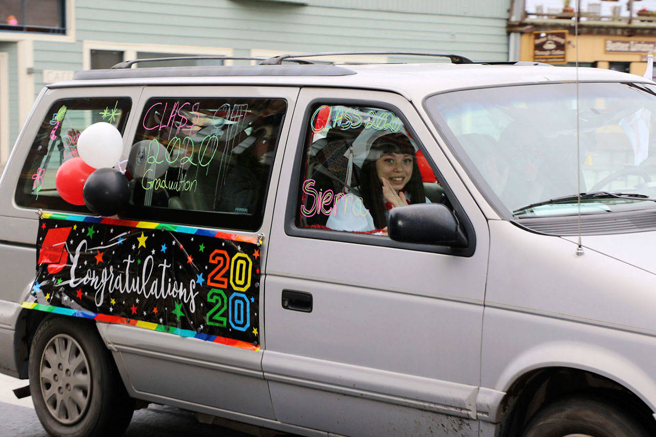 The Port Townsend High School Class of 2020 rolled down Water St. in vehicles as part of its modified graduation celebration Friday. (Ken Park/Peninsula Daily News)