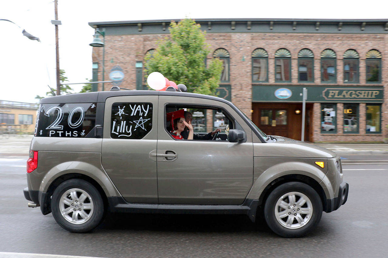 The Port Townsend High School Class of 2020 rolled down Water St. in vehicles as part of its modified graduation celebration Friday. (Ken Park/Peninsula Daily News)