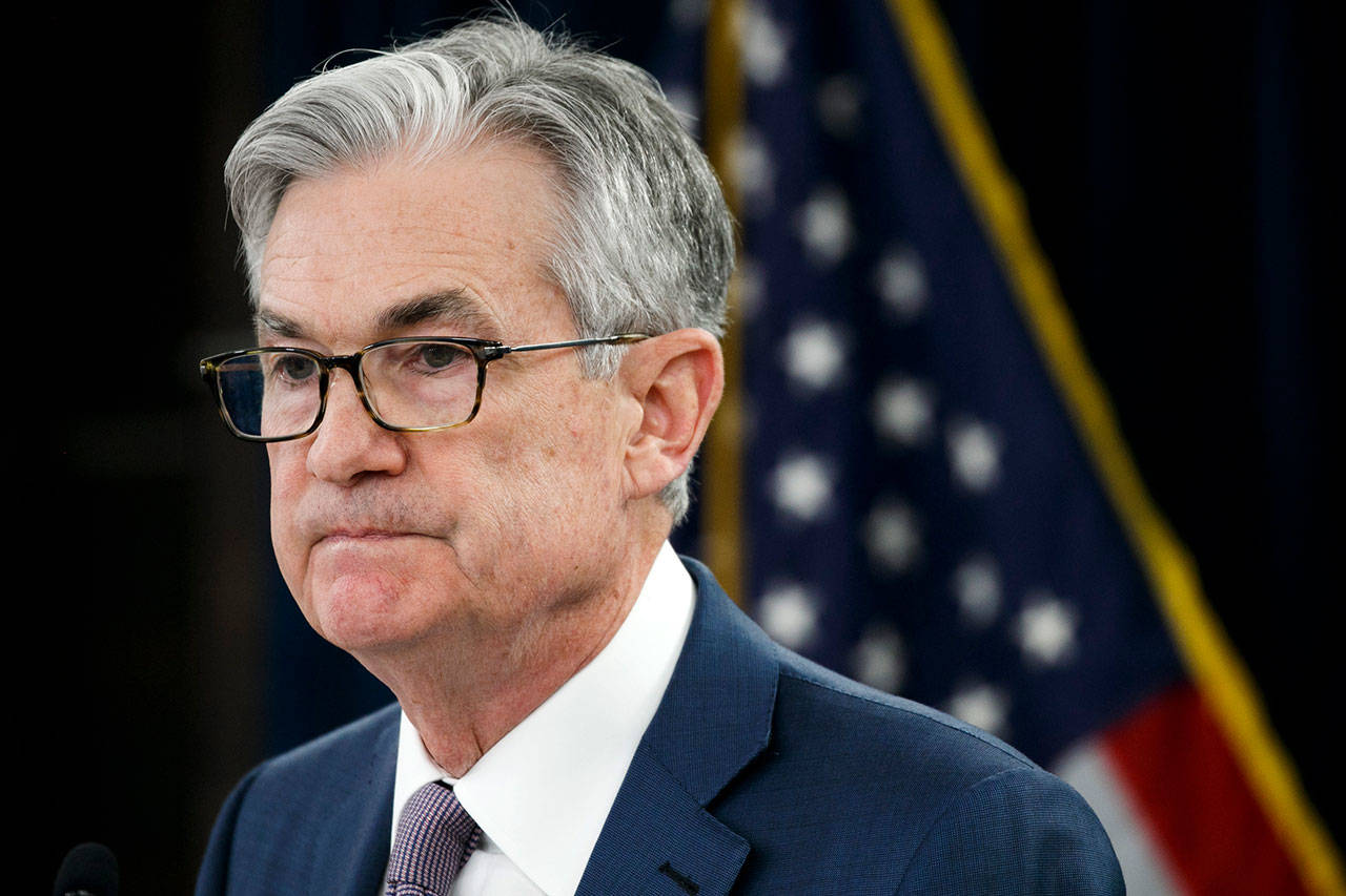 In this Tuesday, March 3, 2020, file photo, Federal Reserve Chair Jerome Powell pauses during a news conference to discuss an announcement from the Federal Open Market Committee, in Washington. The Federal Reserve says it will keep buying bonds, Wednesday, June 10, to maintain low borrowing rates and support the U.S. economy in the midst of a recession. And it says nearly all the Fed’s policymakers foresee no rate hike through 2022. (AP Photo/Jacquelyn Martin, File)