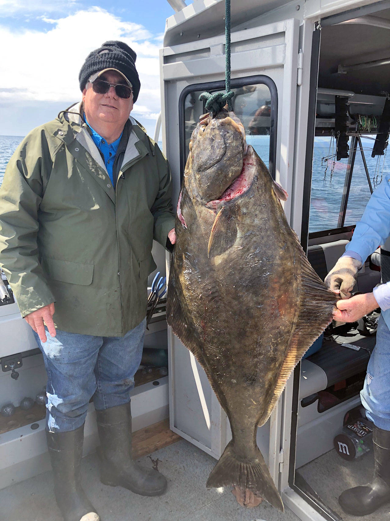 Sequim angler Bob Cooper, with the aid of fishing partners David Johnson and Wally Jenkins, hauled in a 95-pound halibut recently while fishing with herring bait off the Rock Pile near Port Angeles.