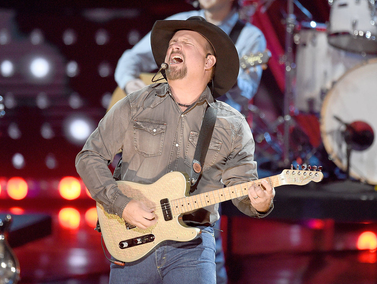 This March 14, 2019 photo shows Garth Brooks performing at the iHeartRadio Music Awards in Los Angeles. Brooks is holding a concert in Nashville,Tenn., that will be played at 300 drive-in theaters across the country. (Photo by Chris Pizzello/Invision/AP)