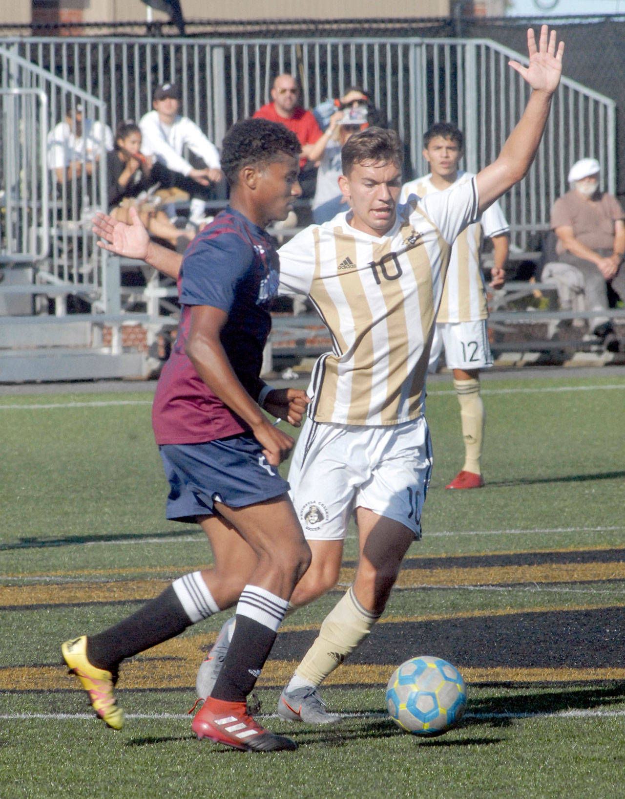 Peninsula’s Mason Haubrich, right, battles for control with Whatcom’s Musab Bwana in September 2019 at Wally Sigmar Field in Port Angeles. Because of the ongoing COVID-19 pandemic, the Northwest Athletic Conference postponed the start of the college soccer season until spring 2021. (Keith Thorpe/Peninsula Daily News)
