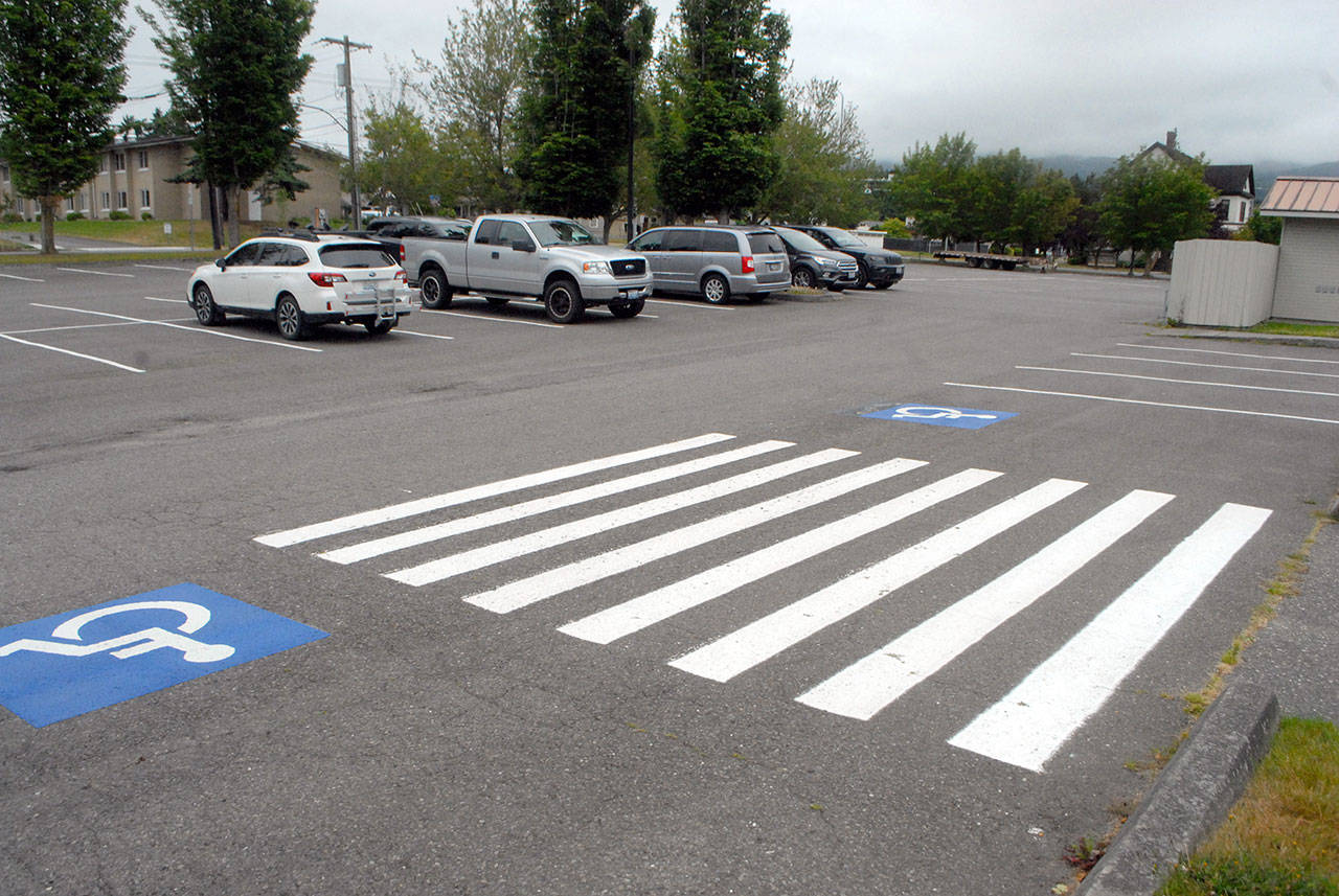 The east parking lot for Port Angeles City Hall and the Vern Burton Community Center, shown Friday, is slated to be repaved with a permeable surface to protect nearby Peabody Creek from stormwater pollution. (Keith Thorpe/Peninsula Daily News)