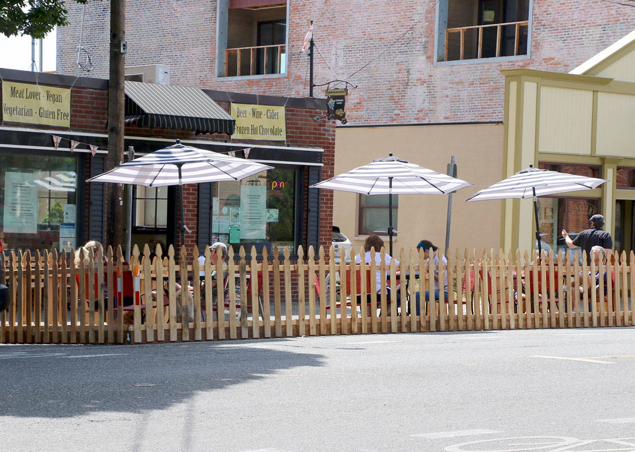 Restaurants participating in Port Townsend’s “streatery” experiment have been transforming parking spaces in front of their buildings into patios on which customers can enjoy meals while maintaining social distancing. (Ken Park/Peninsula Daily News)