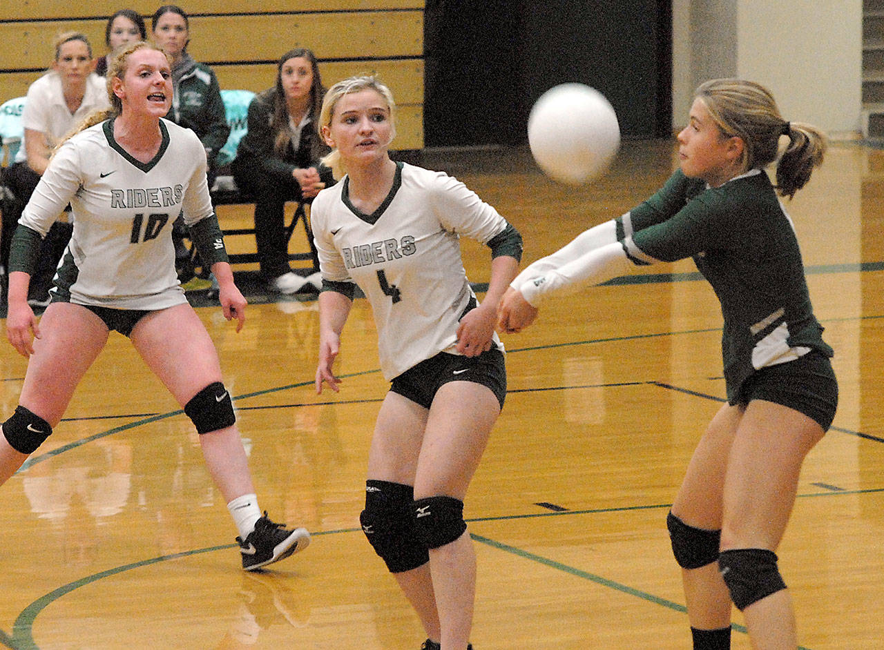 Port Angeles libero Lily Halberg, right, bumps the ball as teammates, from left, Kennedy Bruch and McKenzie Musalek look on during the first set of an October 2019 match against Kingston. (Keith Thorpe/Peninsula Daily News file)