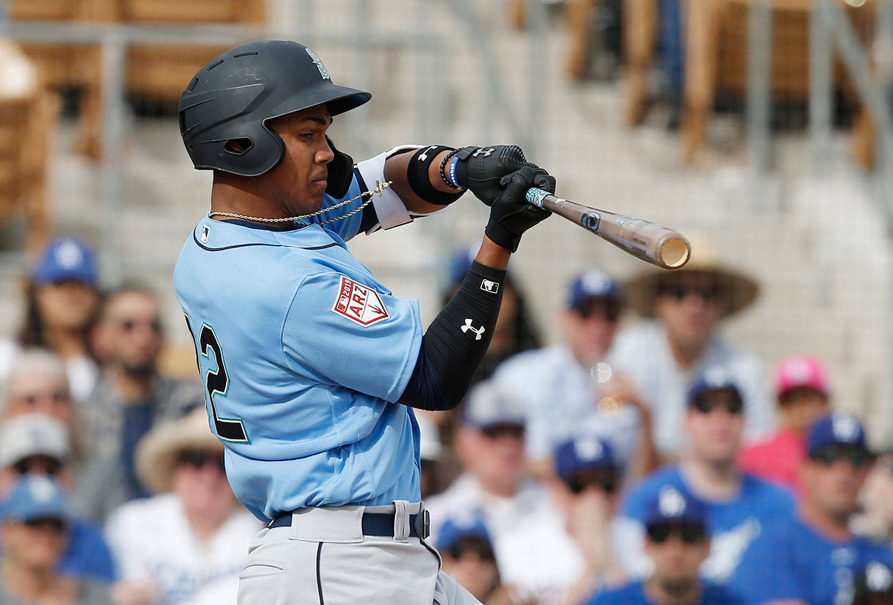 Seattles Julio Rodriguez swings during a 2019 spring training contest. Rodriguez, the teams No. 2 overall prospect, suffered a hairline fracture of his left wrist the team confirmed Thursday. (Sue Ogrocki/Associated Press file)