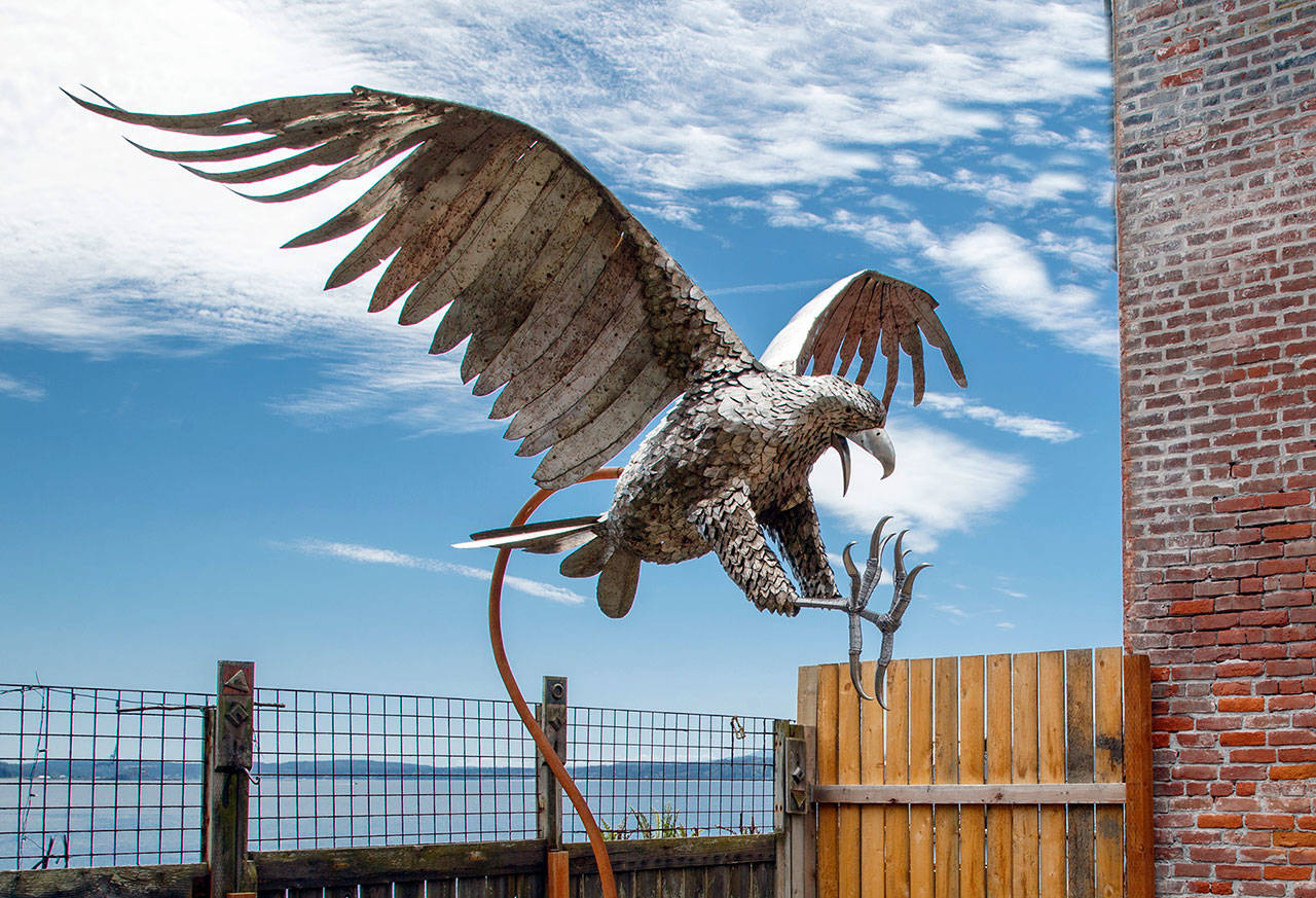 Gary Neal’s depiction of an eagle on the hunt hangs above the Garden Gallery.