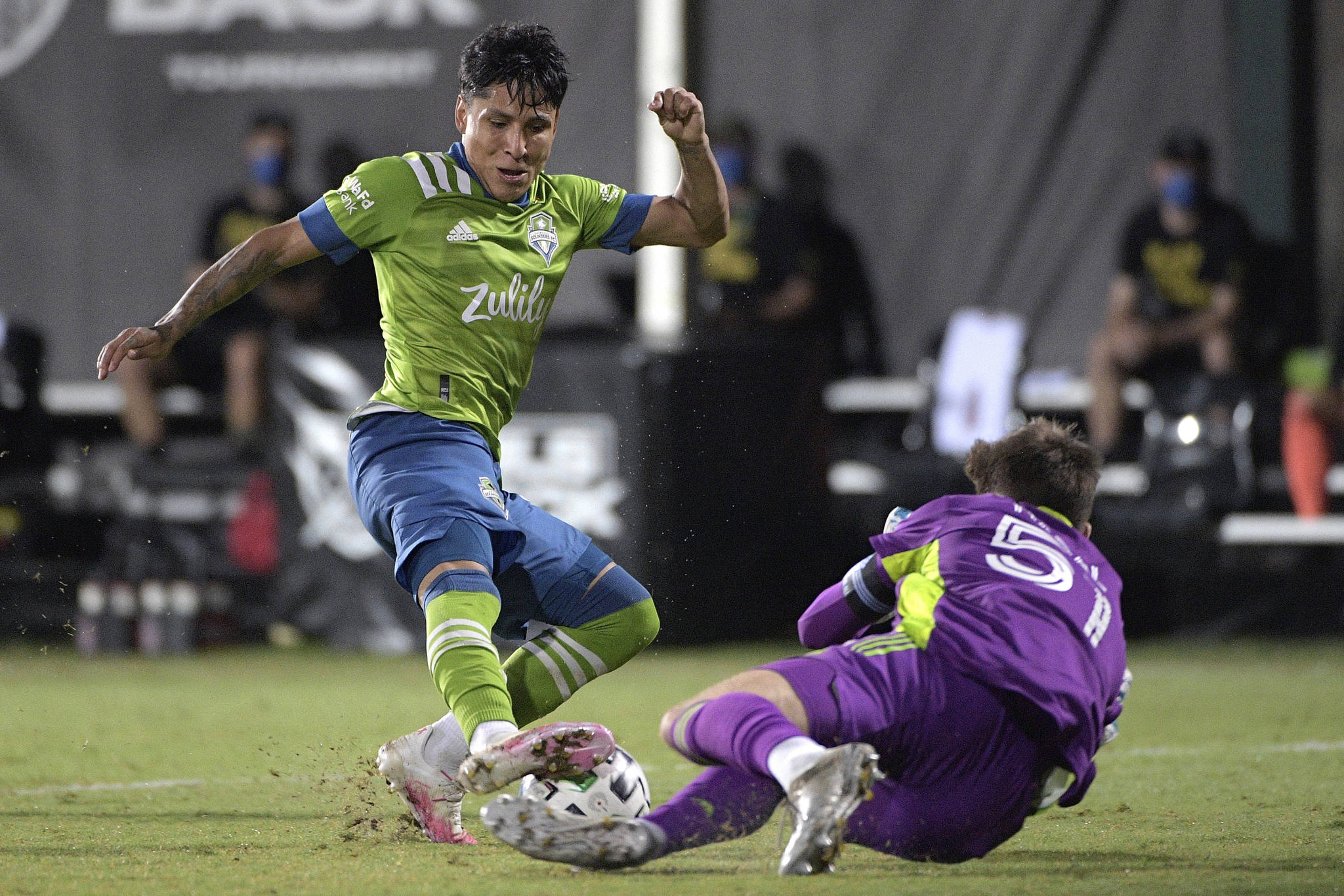 Seattle Sounders forward Raul Ruidiaz (9) has his shot blocked by Vancouver Whitecaps goalkeeper Thomas Hasal (51) during the second half of an MLS soccer match, Sunday, July 19, 2020, in Kissimmee, Fla. (AP Photo/Phelan M. Ebenhack)