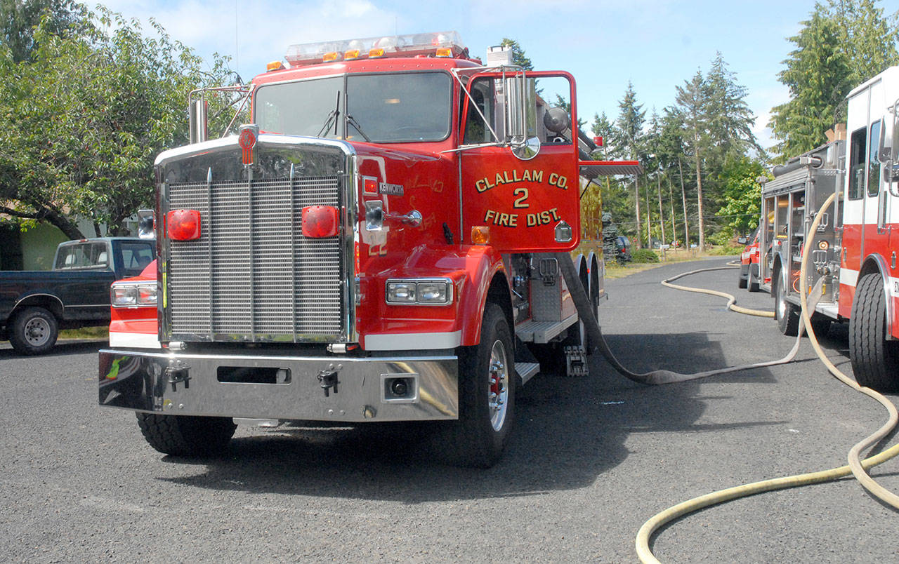 Clallam County Fire District 2 tender 22, which the istrict acquired in 1993, operates on the scene of a grarge fire on Wednesday, July 23, 2020, west of Port Angeles. (Keith Thorpe/Peninsula Daily News)