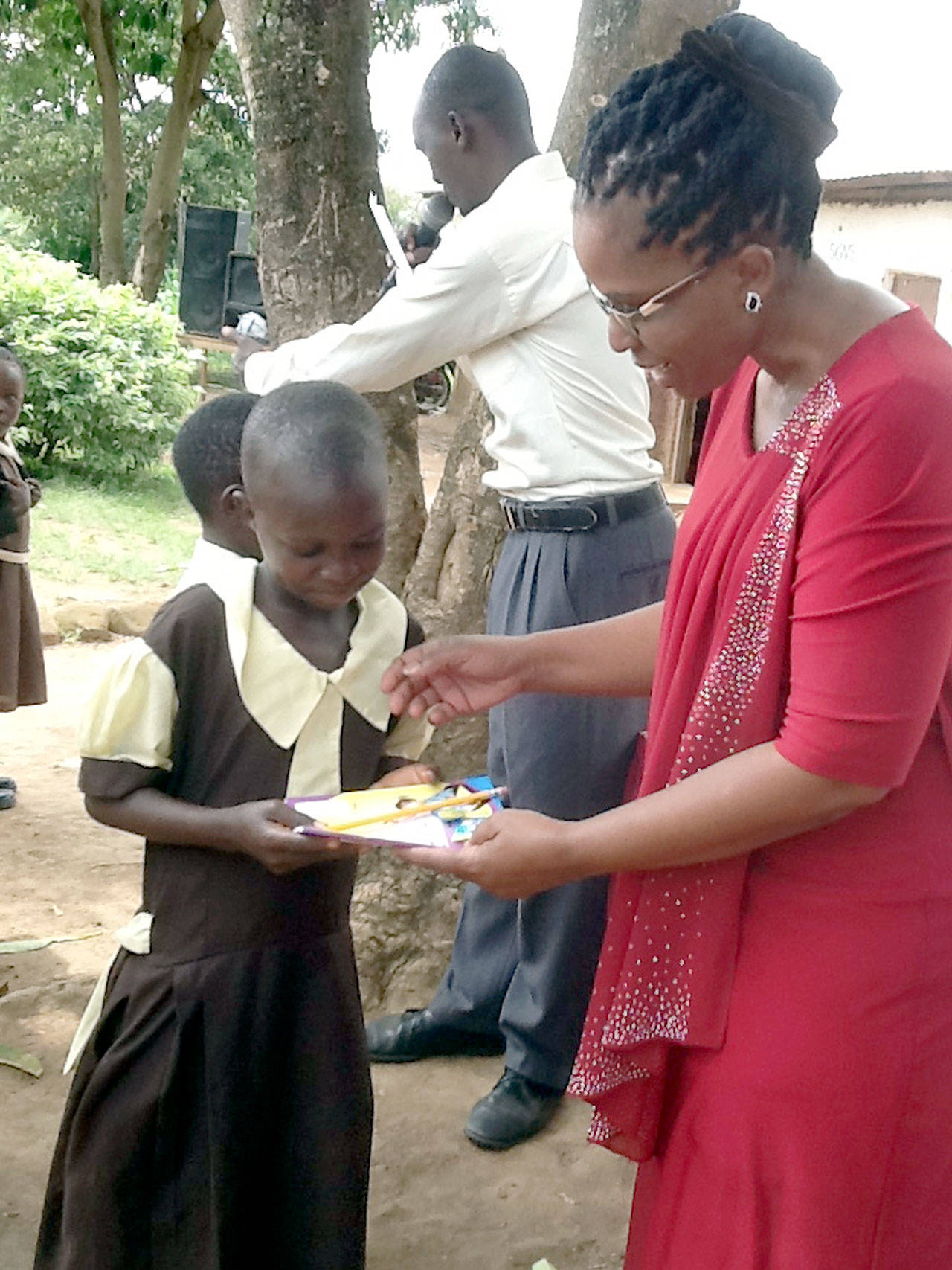 At the Star of Hope Centre in Bungoma, Kenya, Gladwell Sempele Muyelele congratulates a student during a graduation party. (Photo courtesy of Star of Hope Centre)