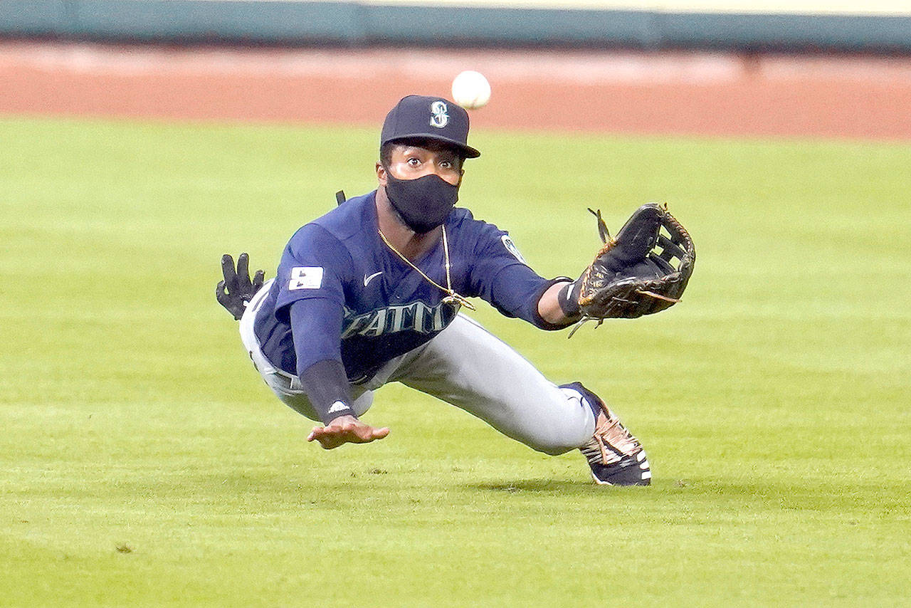 Seattle Mariners right fielder Mallex Smith dives as he tries to catch an RBI single by Houston Astros Alex Bregman during the fifth inning of a baseball game Friday, July 24, 2020, in Houston. (AP Photo/David J. Phillip)
