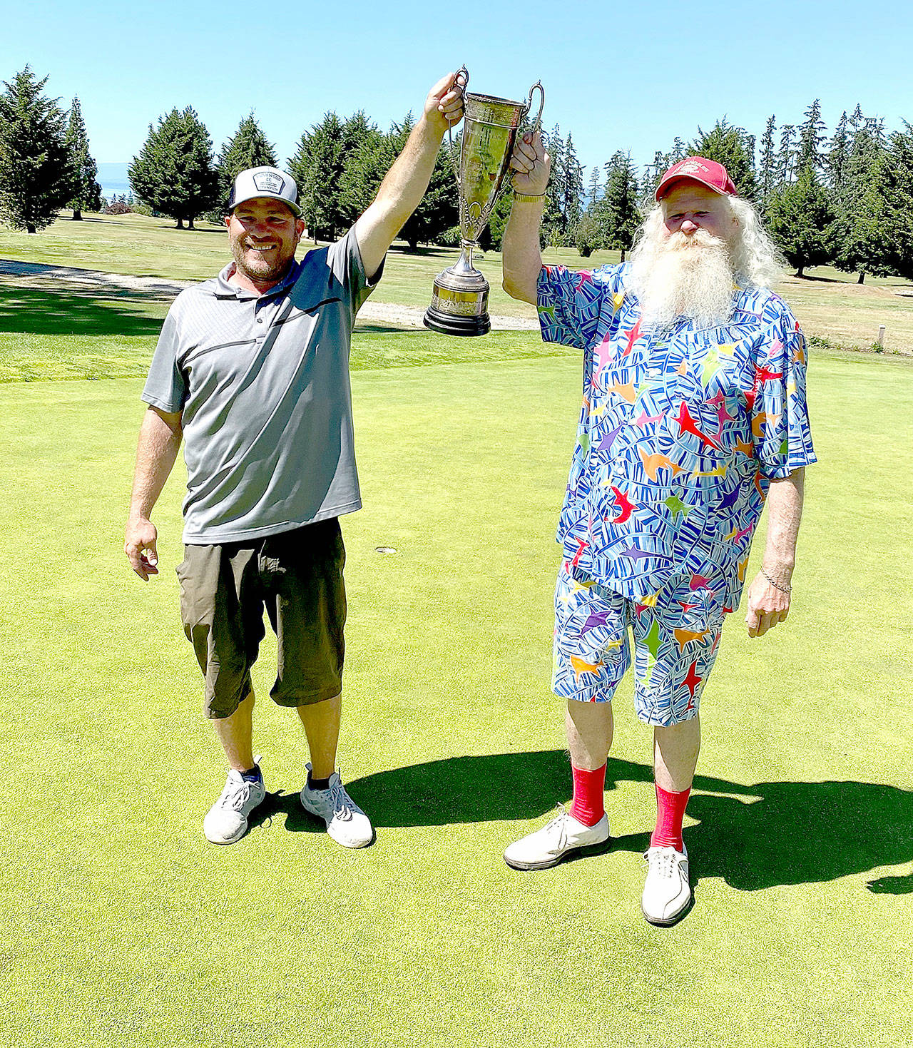 Gross winner Jade Tisdale, left, and net winner Al Osterberg show off their winners trophy Sunday at the Port Angeles Golf and Country Club after winning the Mens Club Championship. (Submitted photo)