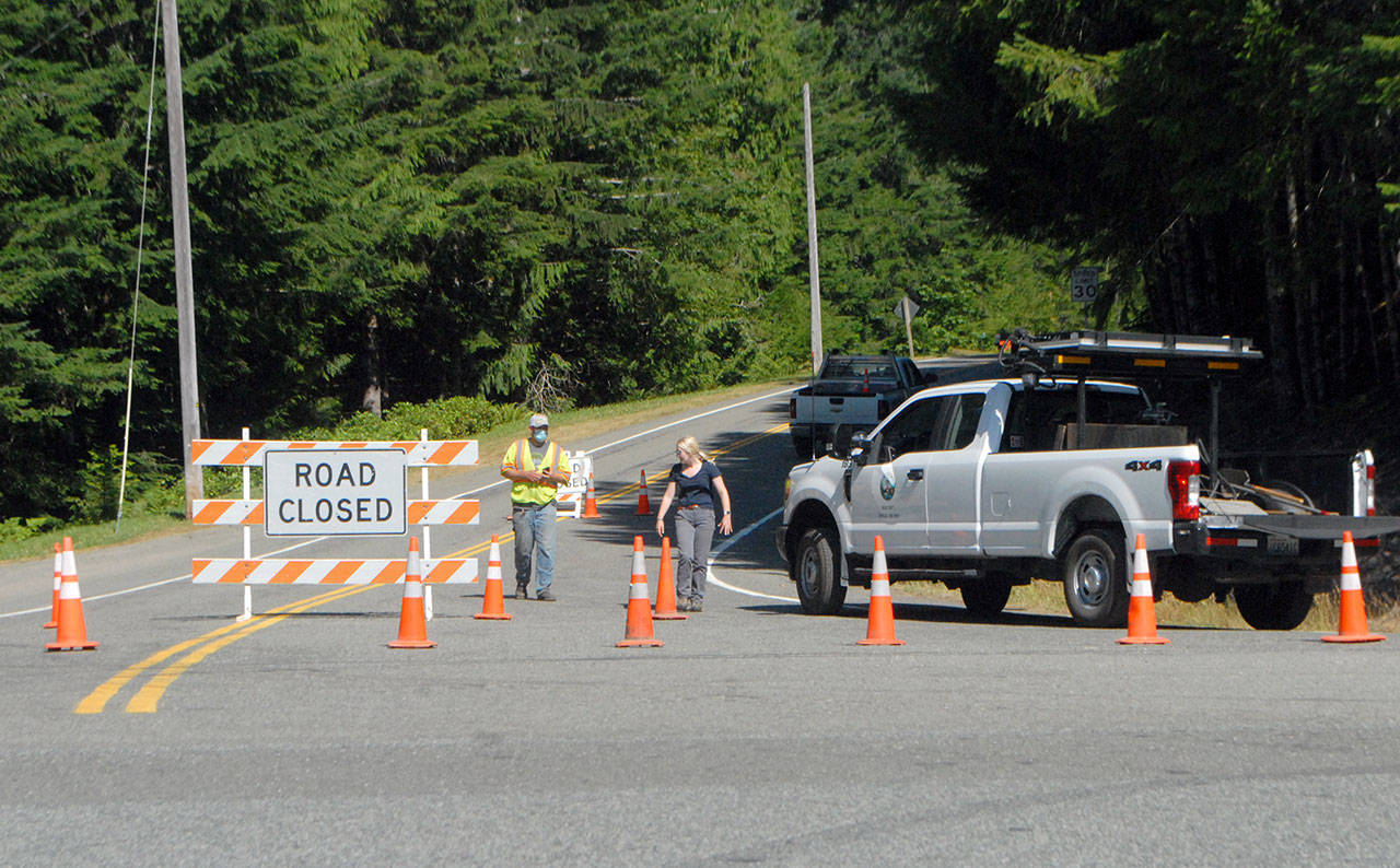 Barricades block access to East Beach Road at the intersection of U.S. Highway 101 near Lake Crescent on Thursday. (Keith Thorpe/Peninsula Daily News)