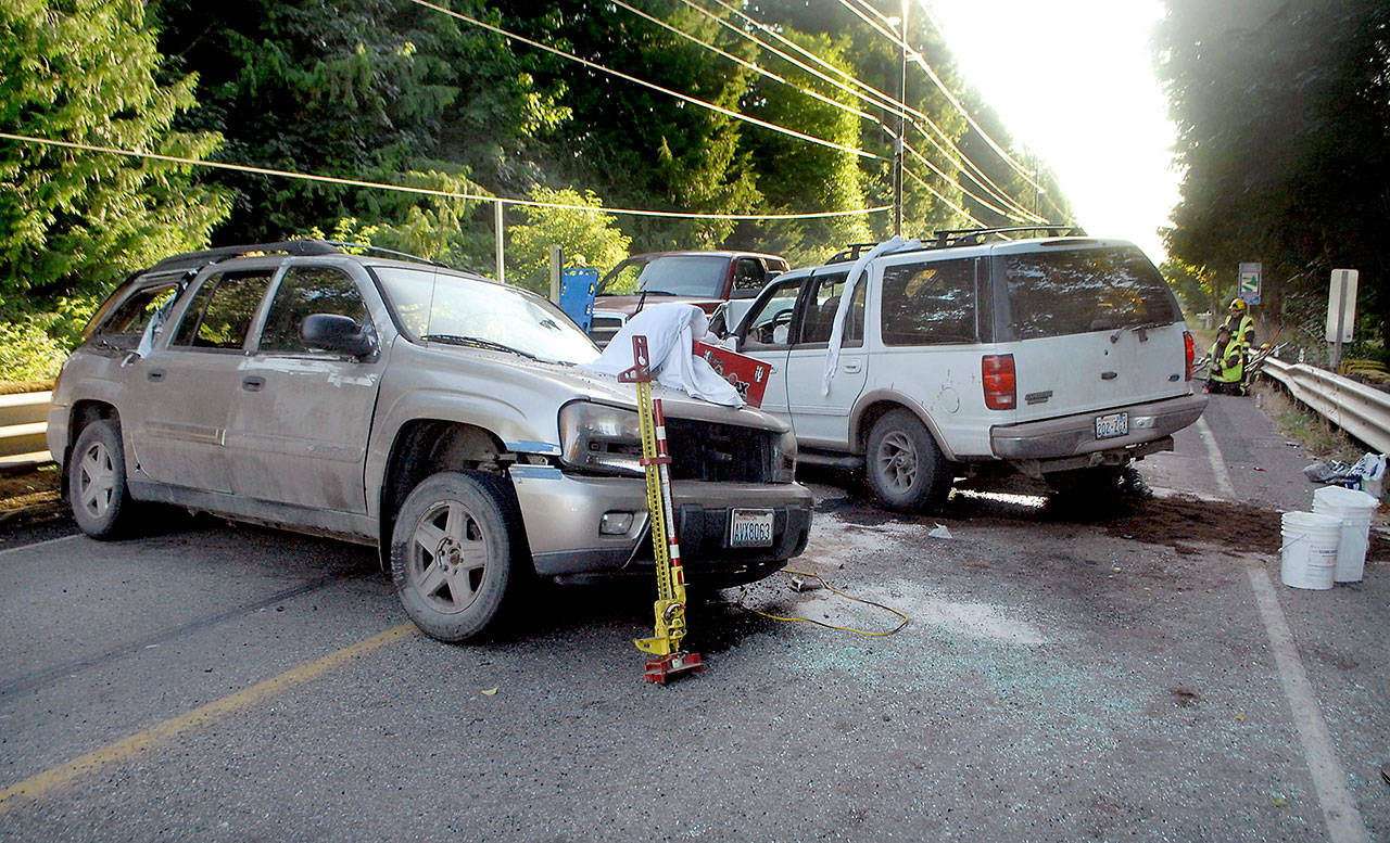 Vehicles block State Highway 112 at Salt Creek east of Joyce on Tuesday evening after a collision resulted in multiple injuries and a closure of the highway in both directions. (Keith Thorpe/Peninsula Daily News)