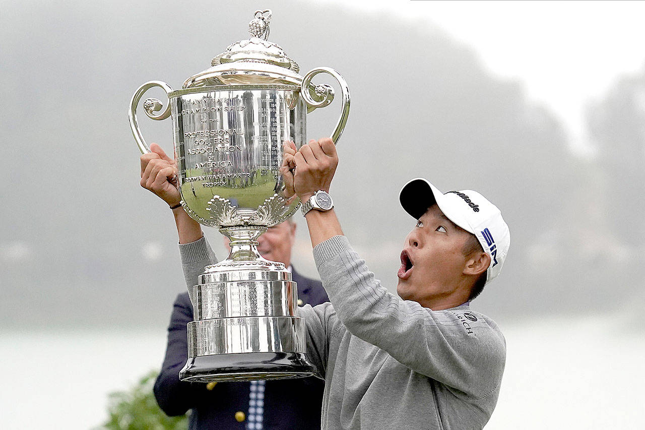 Collin Morikawa reacts as the top of the Wanamaker Trophy falls after winning the PGA Championship golf tournament at TPC Harding Park on Sunday, Aug. 9, 2020, in San Francisco. (Jeff Chiu/Associated Press)