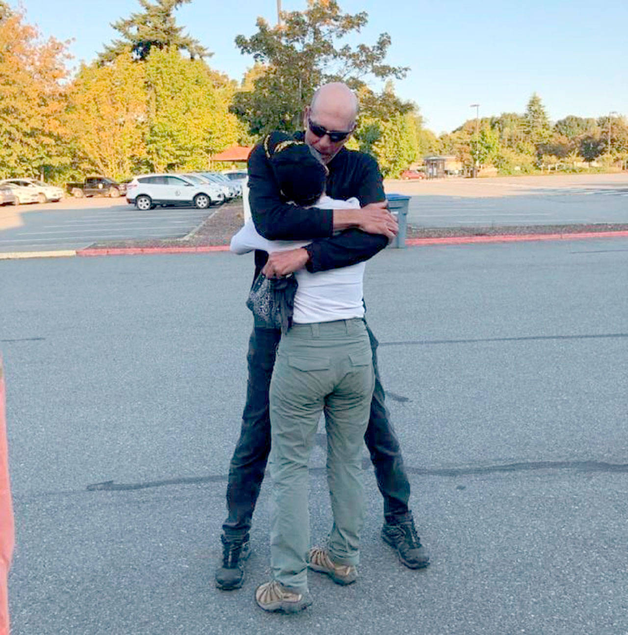Rescued hiker Stephanie Lincoln embraces her husband Brad Rosenthal after the pair were reunited Monday evening following Lincoln’s 60-hour ordeal on federal wilderness land east of Forks.