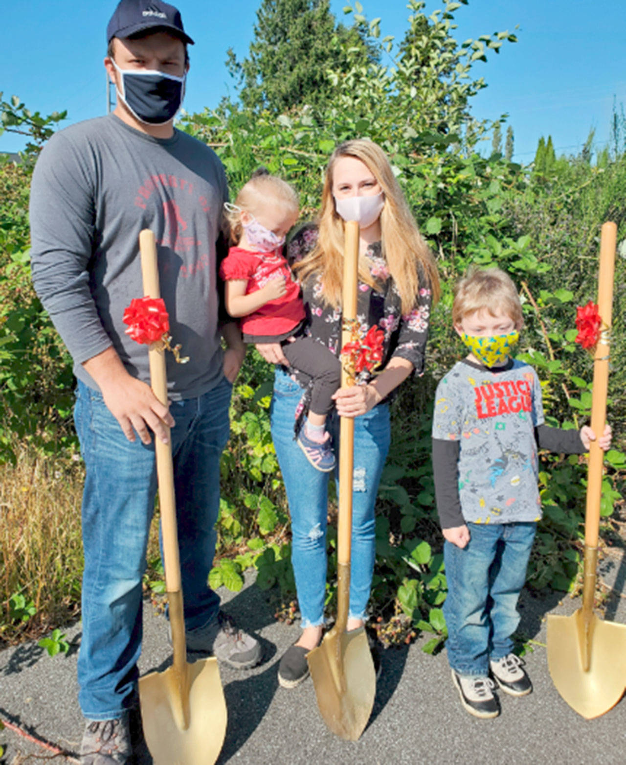 The Whidden family, from left, Michael Whidden, Elizabeth Whidden, Samantha Campos and Benjamin Camp break ground for a Peninsula Housing Authority home in Forks. They are one of five families beginning to build homes.