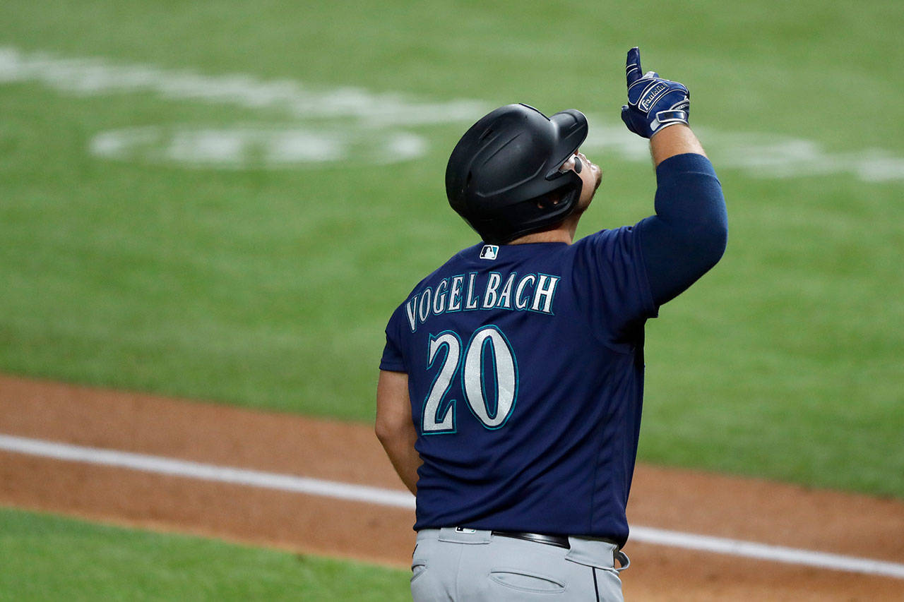 Seattle Mariners’ Daniel Vogelbach (20) celebrates his two-run home run as he approaches home plate in the second inning of a baseball game against the Texas Rangers in Arlington, Texas, on Wednesday, Aug. 12, 2020. The shot scored Shed Long Jr. (Tony Gutierrez/Associated Press)