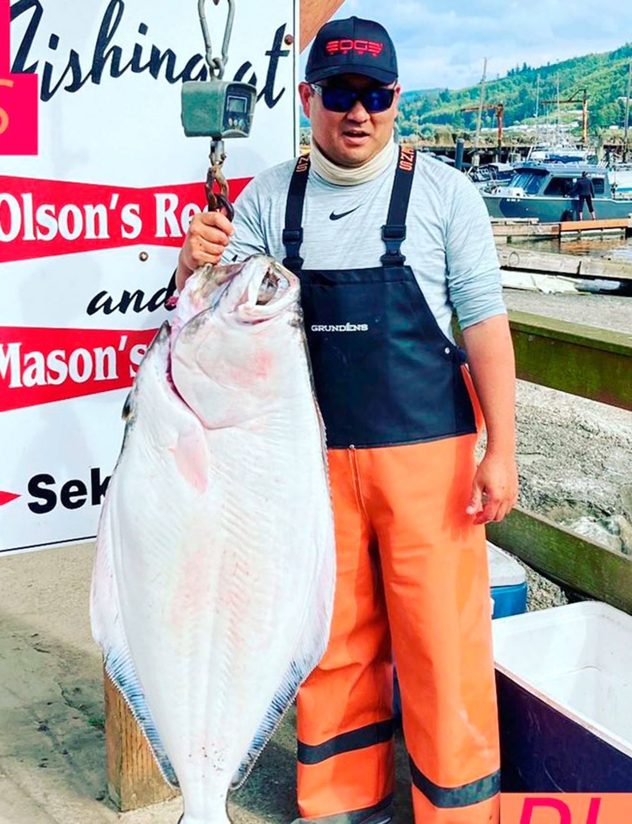 Catch totals for halibut, like this 54-pounder weighed in by Phil Kim at Mason’s Resort in Sekiu earlier this month, should provide opportunities through the month of September for anglers off Neah Bay, in the Strait of Juan de Fuca and Puget Sound. (Photo courtesy of Mason’s Resort)
