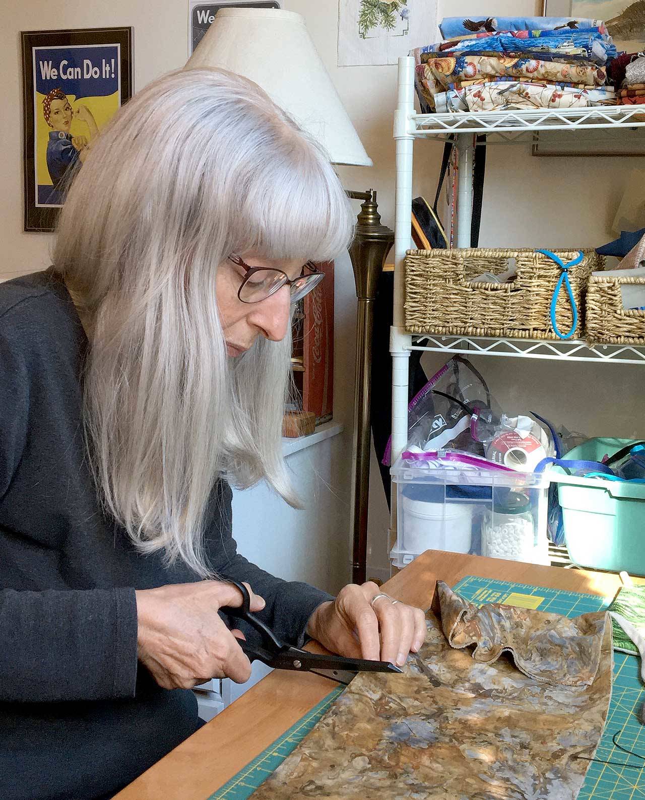 Ellen Cote cuts fabric for face masks at her home in Port Townsend. (Ellen Cote)