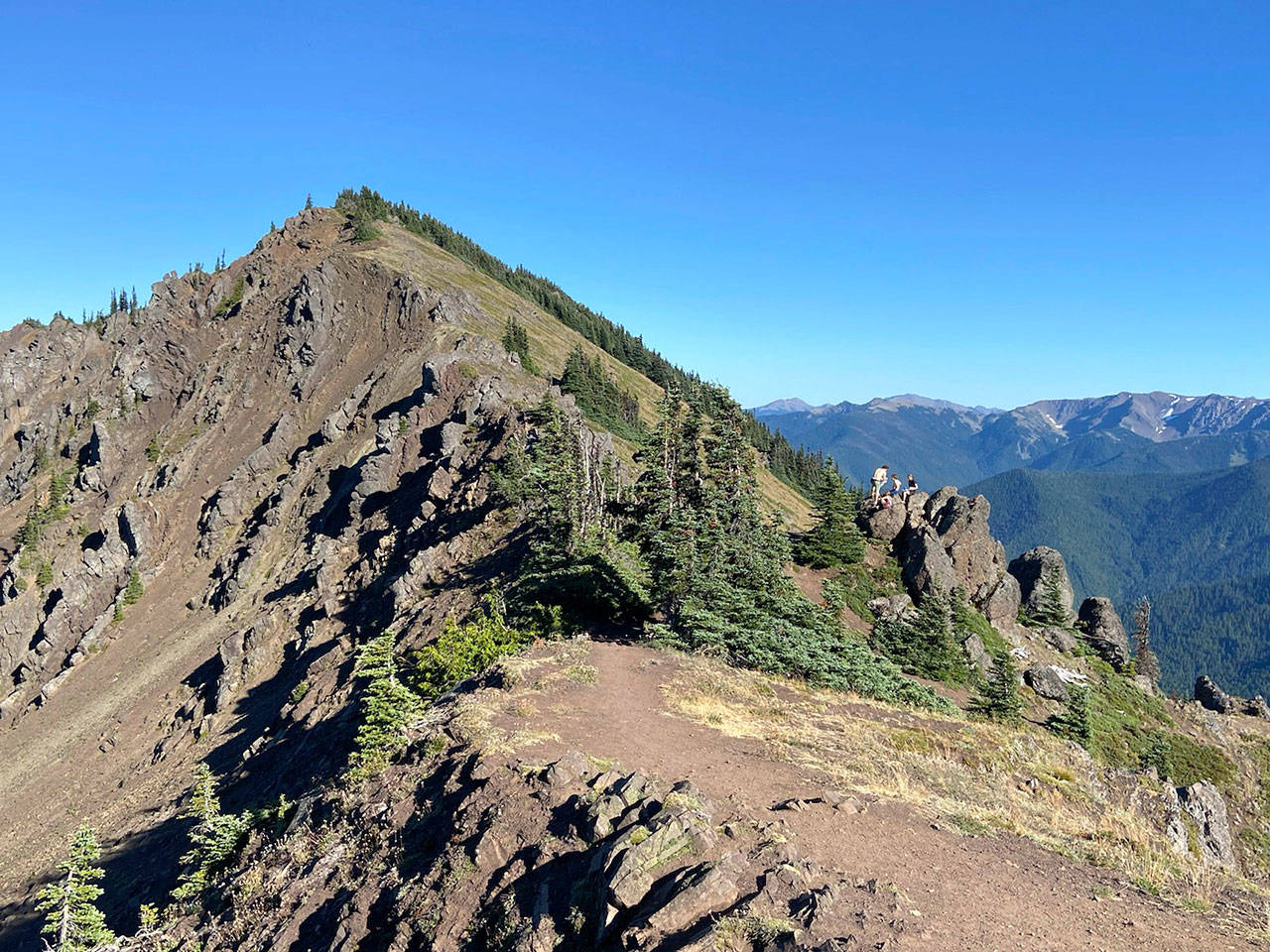 Hikers stop to rest on Klahhane Ridge at the top of Switchback trail on Friday, Aug. 28, 2020. (Rob Ollikainen/Peninsula Daily News)
